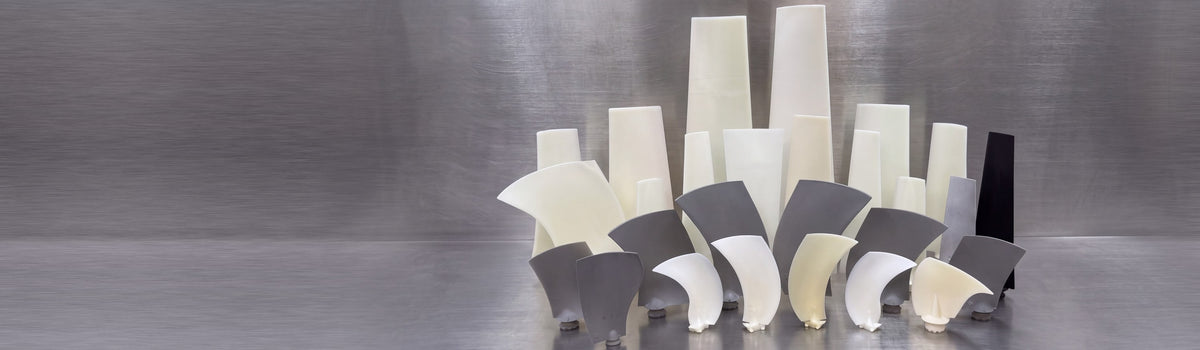 Multiwing and Wing Fan blades of many sizes standing on a stainless steel table